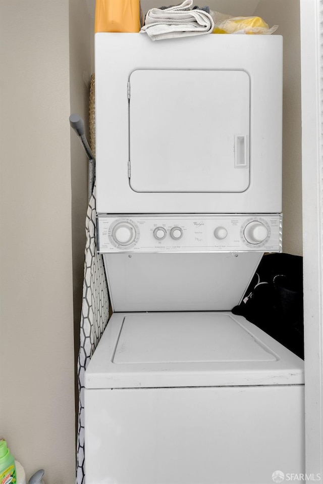 laundry area with stacked washer and clothes dryer