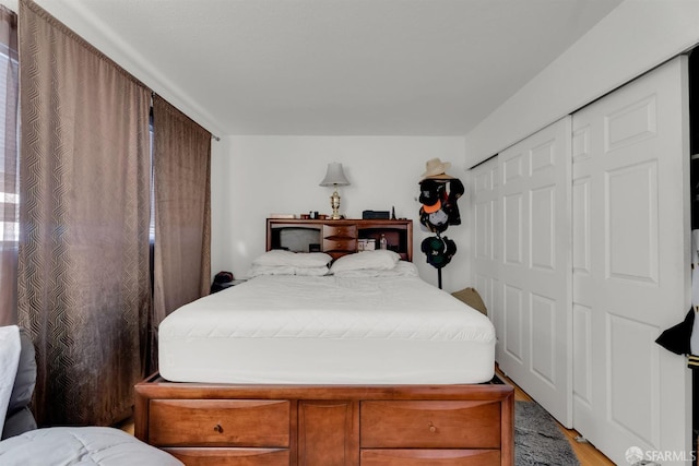 bedroom with hardwood / wood-style flooring and a closet