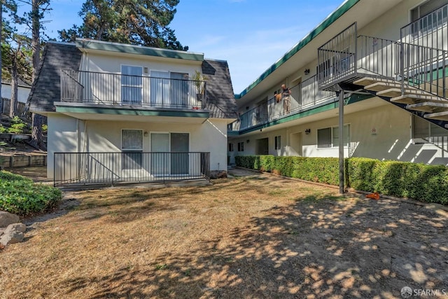 back of house featuring a balcony