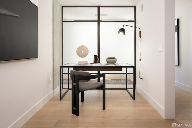 office area with light hardwood / wood-style floors