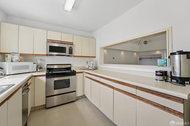 920 Mission Rd Unit 15, South San Francisco, CA 94080 - kitchen with appliances with stainless steel finishes, light countertops, and cream cabinetry