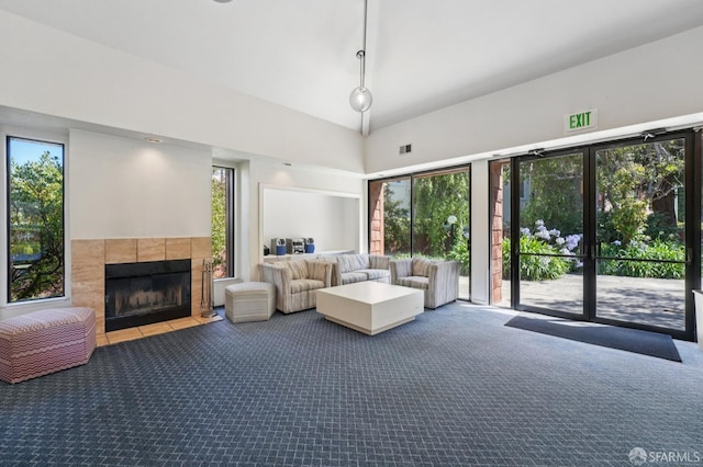 920 Mission Rd Unit 15, South San Francisco, CA 94080 - living area featuring carpet, a tiled fireplace, and a towering ceiling