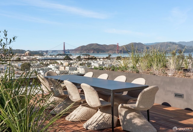 view of patio / terrace featuring a water and mountain view