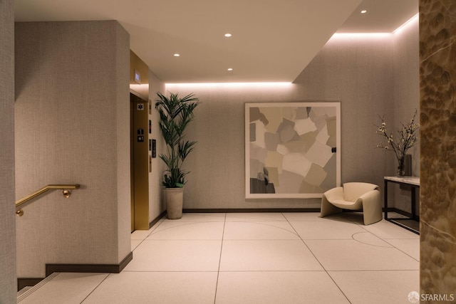 hallway with elevator and light tile patterned flooring