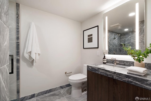 bathroom with vanity, toilet, and a shower with door