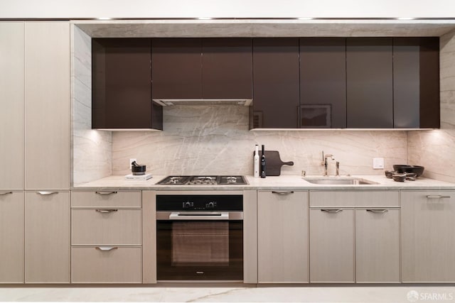 kitchen with decorative backsplash, appliances with stainless steel finishes, and sink