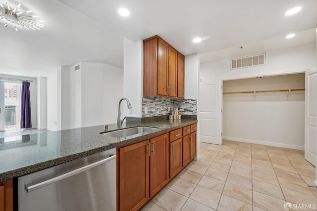 423 7th St Unit 303, Oakland, CA 94607 - kitchen featuring dishwasher, brown cabinets, dark stone countertops, tasteful backsplash, and recessed lighting