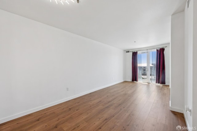 423 7th St Unit 303, Oakland, CA 94607 - unfurnished room with baseboards and wood finished floors