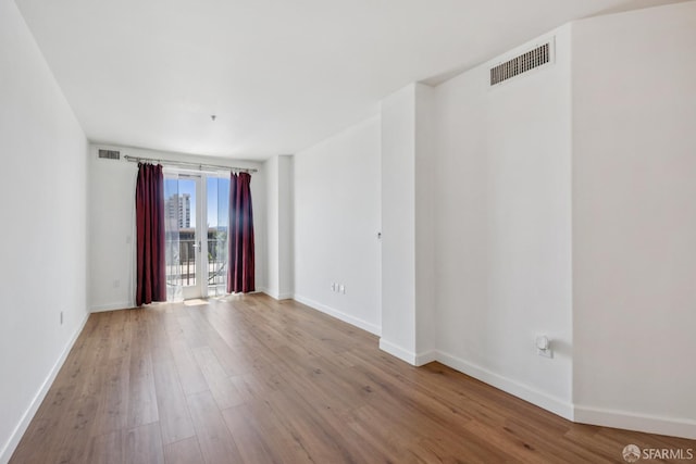 423 7th St Unit 303, Oakland, CA 94607 - spare room with wood finished floors and baseboards