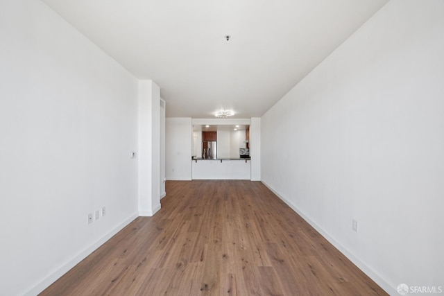 423 7th St Unit 303, Oakland, CA 94607 - unfurnished room featuring wood finished floors and baseboards