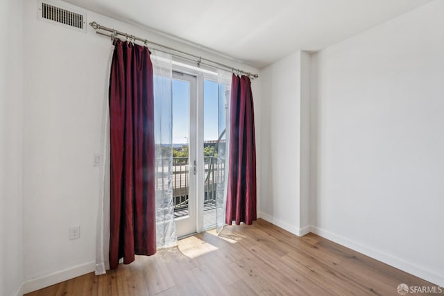 423 7th St Unit 303, Oakland, CA 94607 - spare room featuring wood finished floors and baseboards