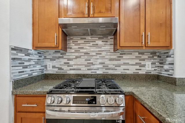 423 7th St Unit 303, Oakland, CA 94607 - kitchen featuring stainless steel range with gas stovetop, range hood, decorative backsplash, and brown cabinetry
