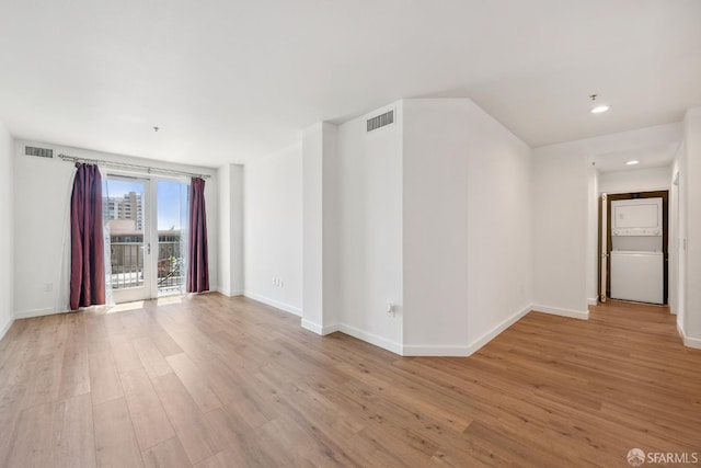 423 7th St Unit 303, Oakland, CA 94607 - unfurnished room with stacked washer and clothes dryer, light wood-type flooring, and recessed lighting