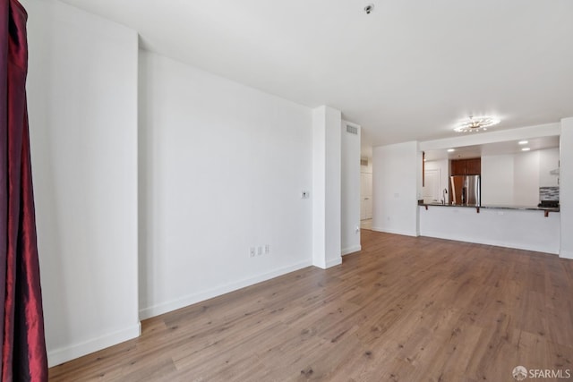 423 7th St Unit 303, Oakland, CA 94607 - unfurnished living room with light wood-style flooring