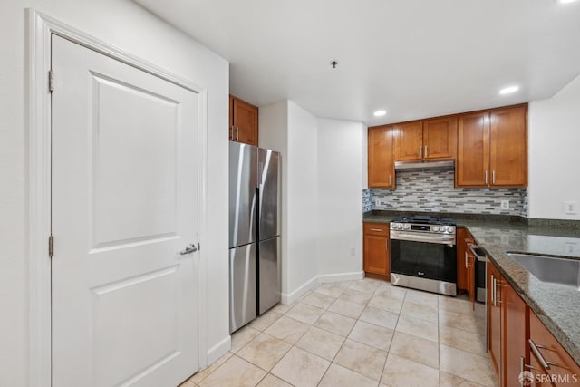423 7th St Unit 303, Oakland, CA 94607 - kitchen with stainless steel appliances, brown cabinetry, under cabinet range hood, backsplash, and recessed lighting