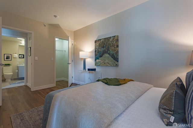 55 Page St Unit 428, San Francisco, CA 94102 - bedroom featuring wood finished floors, baseboards, and ensuite bathroom