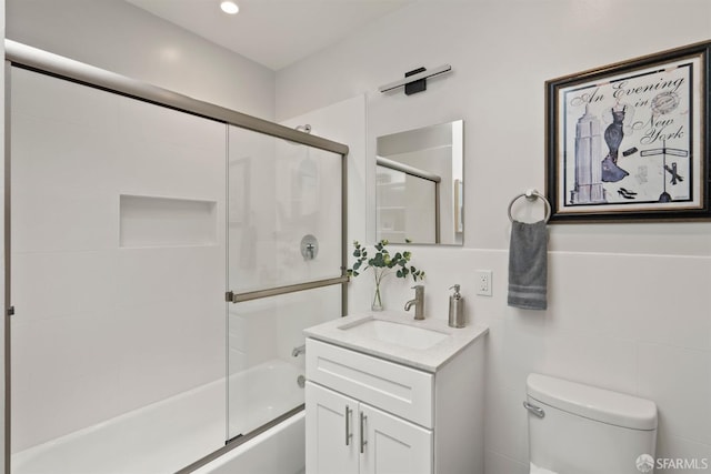 full bathroom with toilet, combined bath / shower with glass door, and vanity