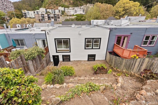 back of property featuring fence