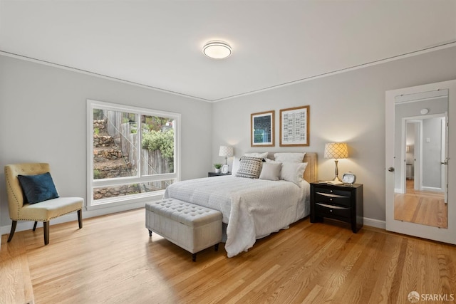 bedroom featuring light wood-type flooring and baseboards