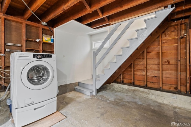 basement with stairway and washer / dryer
