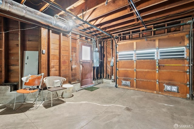 garage featuring wood walls