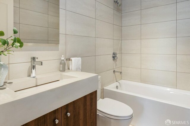 full bathroom featuring toilet, decorative backsplash, tile walls, shower / bathing tub combination, and vanity