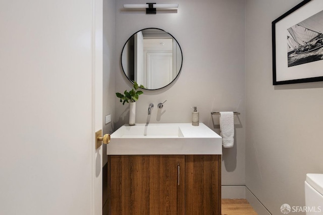 bathroom featuring toilet and vanity