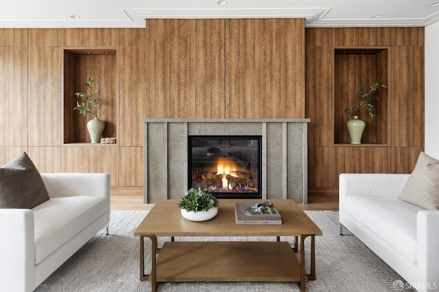 living room with wooden walls and ornamental molding