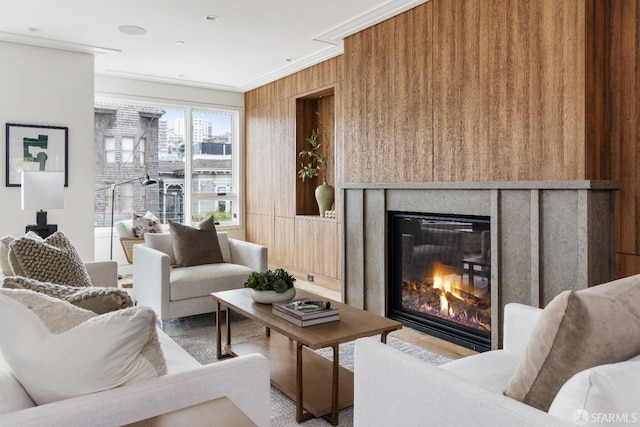 living room featuring wood walls and crown molding