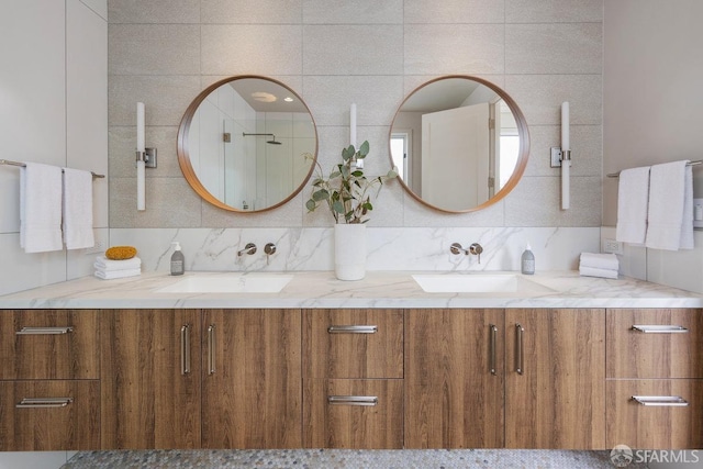 bathroom featuring vanity and tasteful backsplash