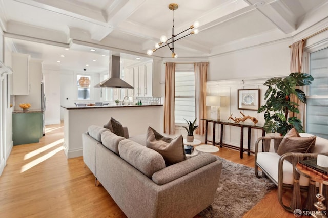 living room featuring beam ceiling, light hardwood / wood-style floors, coffered ceiling, and a wealth of natural light