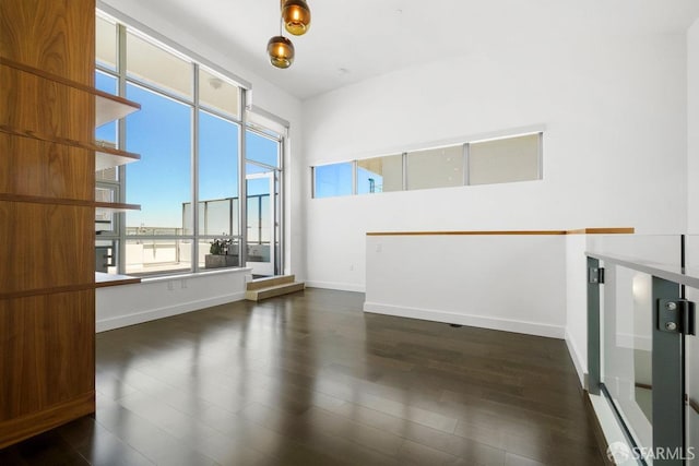 empty room with dark hardwood / wood-style flooring