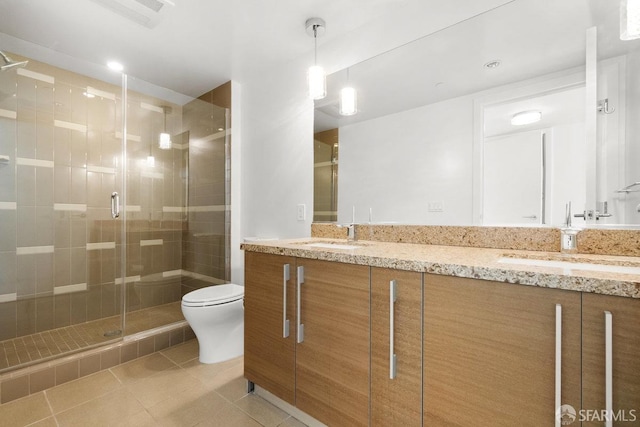 bathroom featuring vanity, toilet, an enclosed shower, and tile patterned flooring