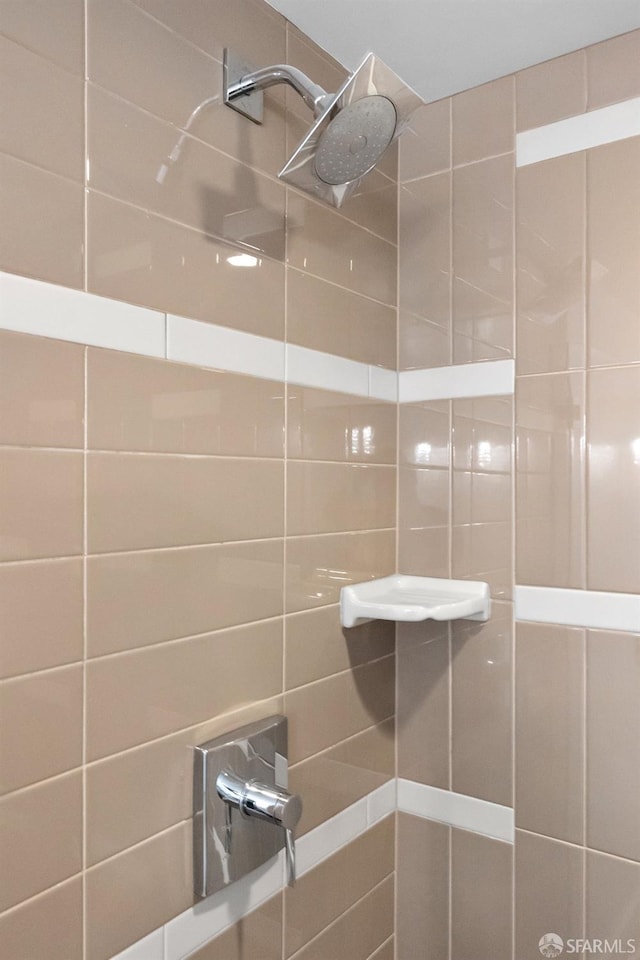 bathroom with tiled shower