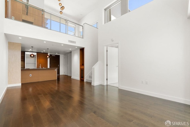 unfurnished living room with dark hardwood / wood-style flooring