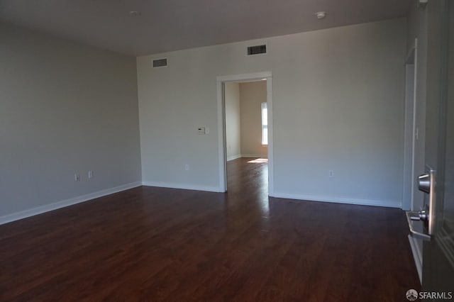 empty room with dark wood-type flooring