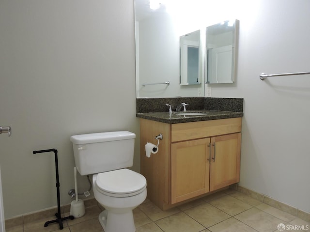 bathroom with vanity, tile patterned flooring, and toilet