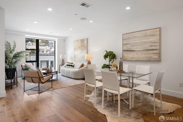 dining space with recessed lighting, visible vents, light wood-style flooring, and baseboards