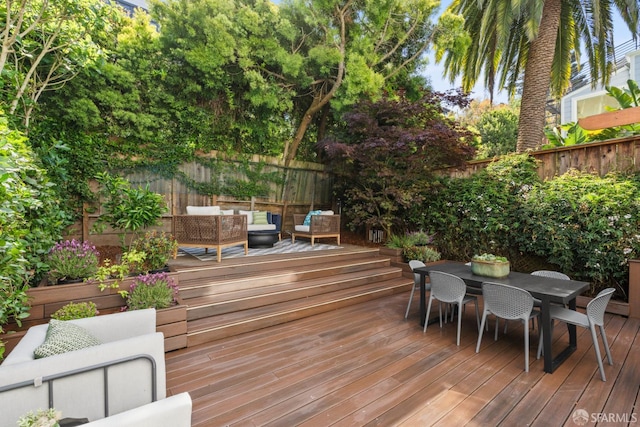 deck featuring an outdoor living space, a fenced backyard, and outdoor dining area