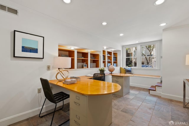 office with baseboards, recessed lighting, ornamental molding, built in study area, and stone tile flooring