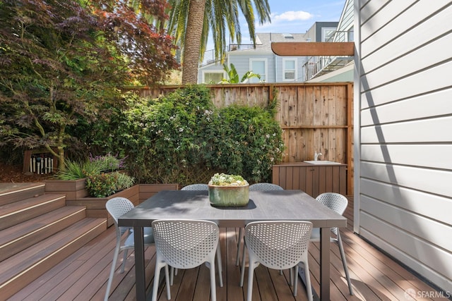 deck featuring fence and outdoor dining space