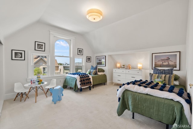 bedroom with lofted ceiling, light carpet, and baseboards