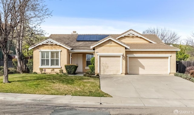 ranch-style home featuring a garage, a front lawn, and solar panels