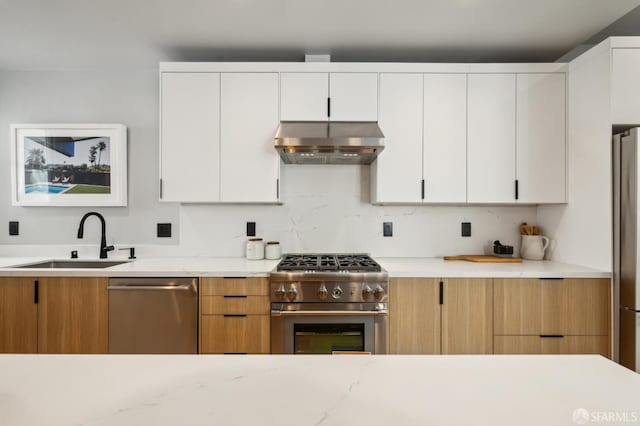 1029 Jackson St Unit 1031, San Francisco, CA 94133 - kitchen featuring wall chimney exhaust hood, stainless steel appliances, a sink, and white cabinetry
