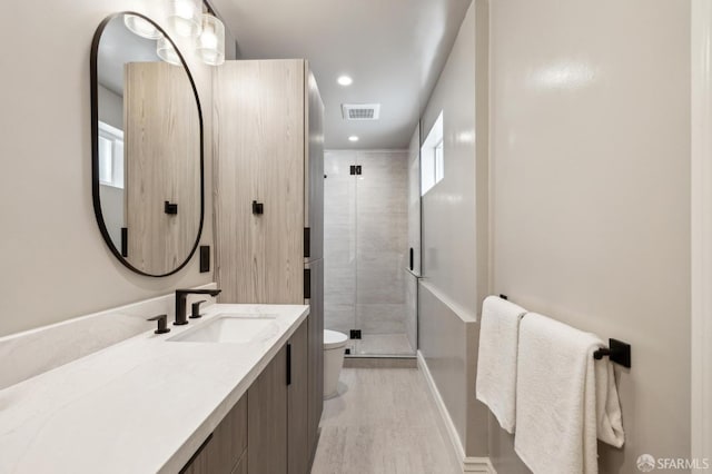 1029 Jackson St Unit 1031, San Francisco, CA 94133 - bathroom with toilet, vanity, a stall shower, wood finished floors, and recessed lighting