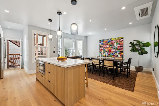 1029 Jackson St Unit 1031, San Francisco, CA 94133 - kitchen featuring modern cabinets, a center island, light wood-type flooring, stainless steel appliances, and recessed lighting