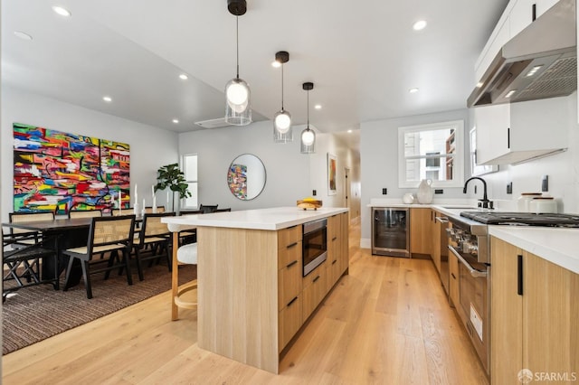 1029 Jackson St Unit 1031, San Francisco, CA 94133 - kitchen featuring premium range hood, modern cabinets, wine cooler, stainless steel microwave, and a sink