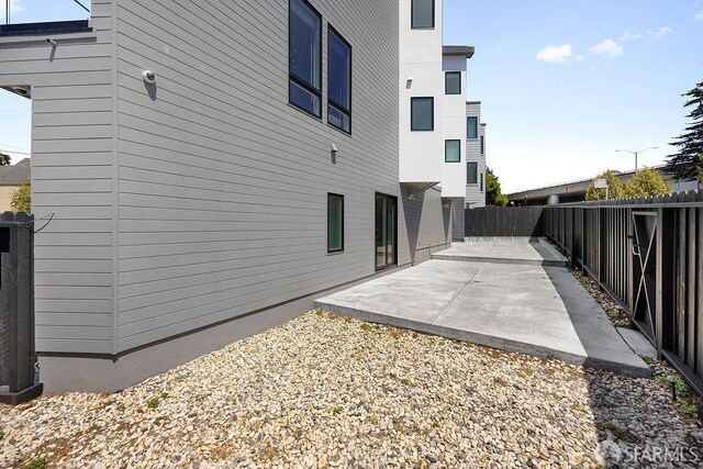 299 Sagamore St, San Francisco, CA 94112 - view of side of home with a fenced backyard and a patio area
