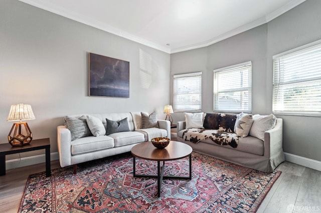 living room with crown molding, a healthy amount of sunlight, and wood-type flooring