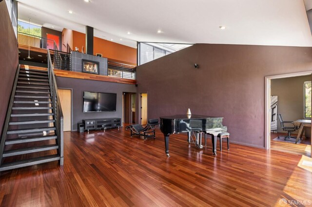 6353 Skyline Blvd, Oakland, CA 94611 - living area featuring wood finished floors, stairway, a towering ceiling, and recessed lighting